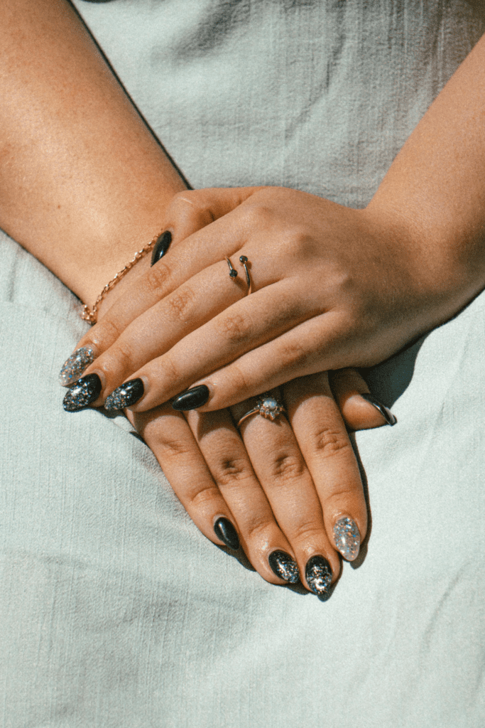 Short elegant nails with rings styled for nail biters to create a clean and expensive look