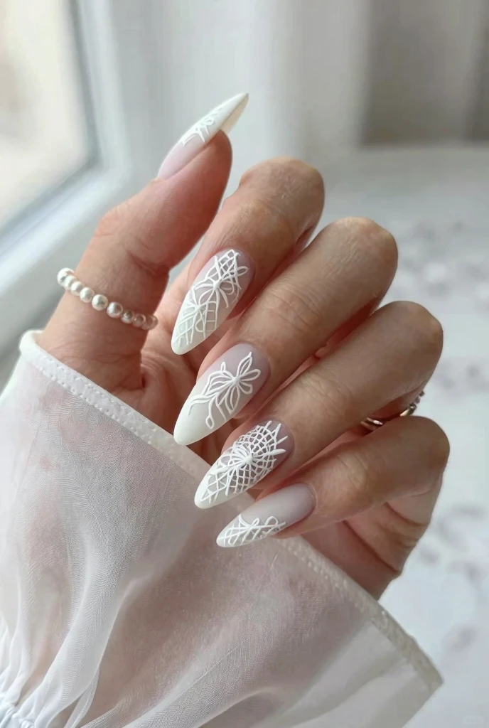 spring nail ideas 2026 with white lace nail art on long almond nails with matte finish