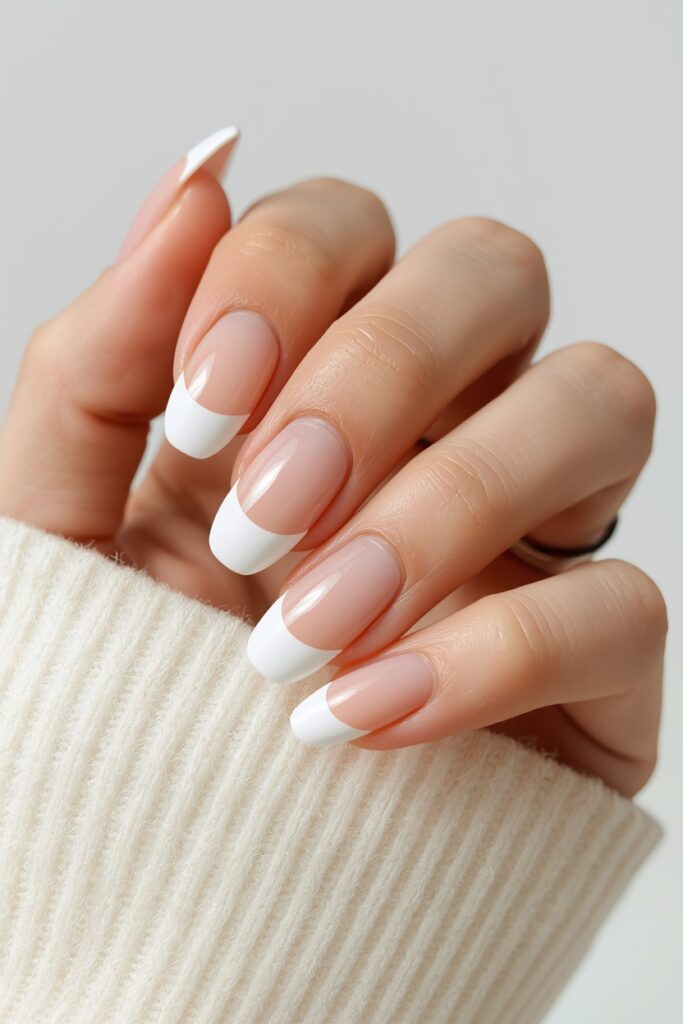Classic white French tip prom nails with thin line on almond shape 2026