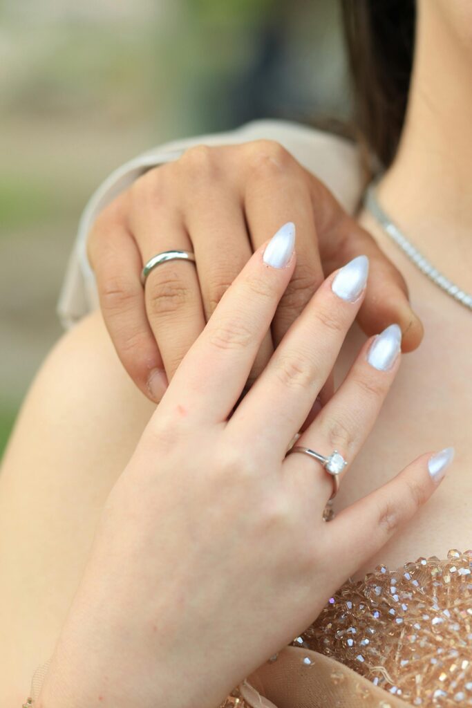  Pearl white almond bridal nails 2026 with engagement ring on hand