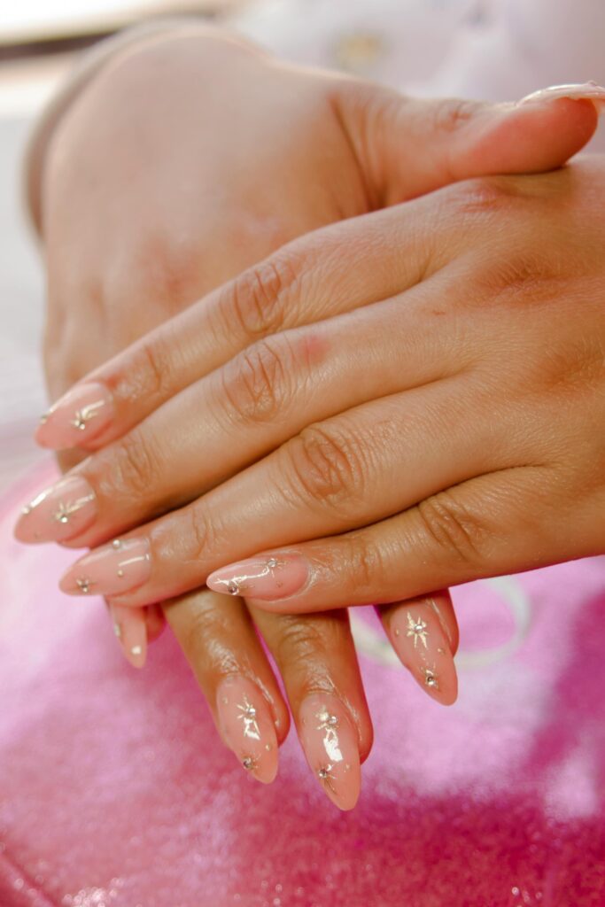 wedding nail ideas 2026 nude almond nails with crystal gem accents