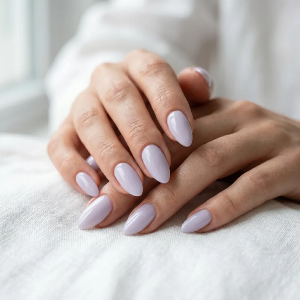 Mother's Day nails 2026 &mdash; milky lavender gel polish on almond-shaped nails, soft spring manicure