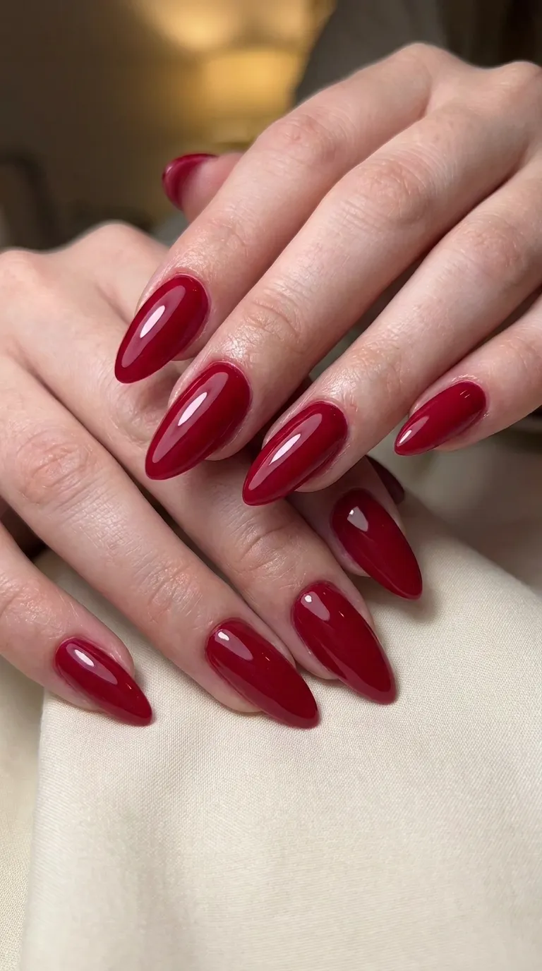 Cherry red glossy manicure on short almond nails