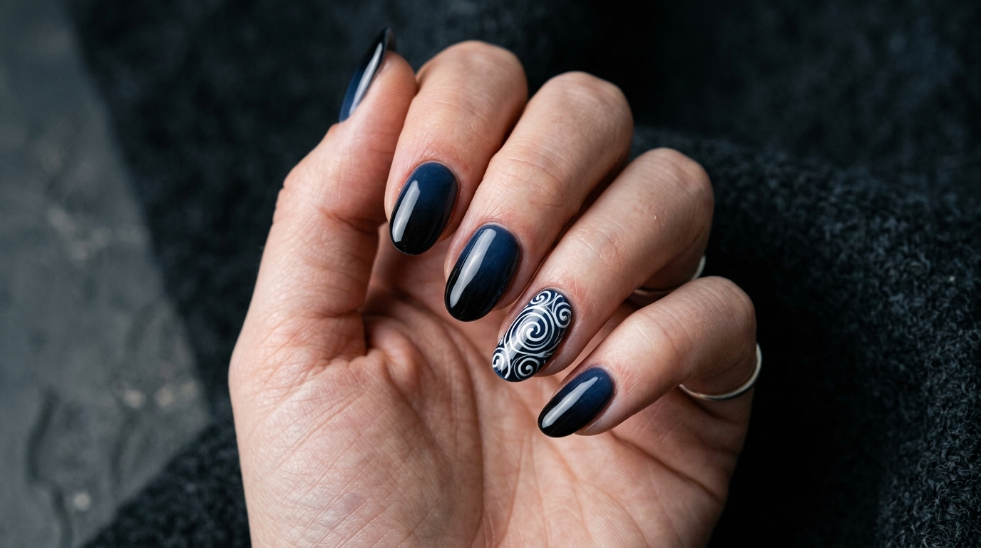 navy to black ombre nails with a white spiral accent