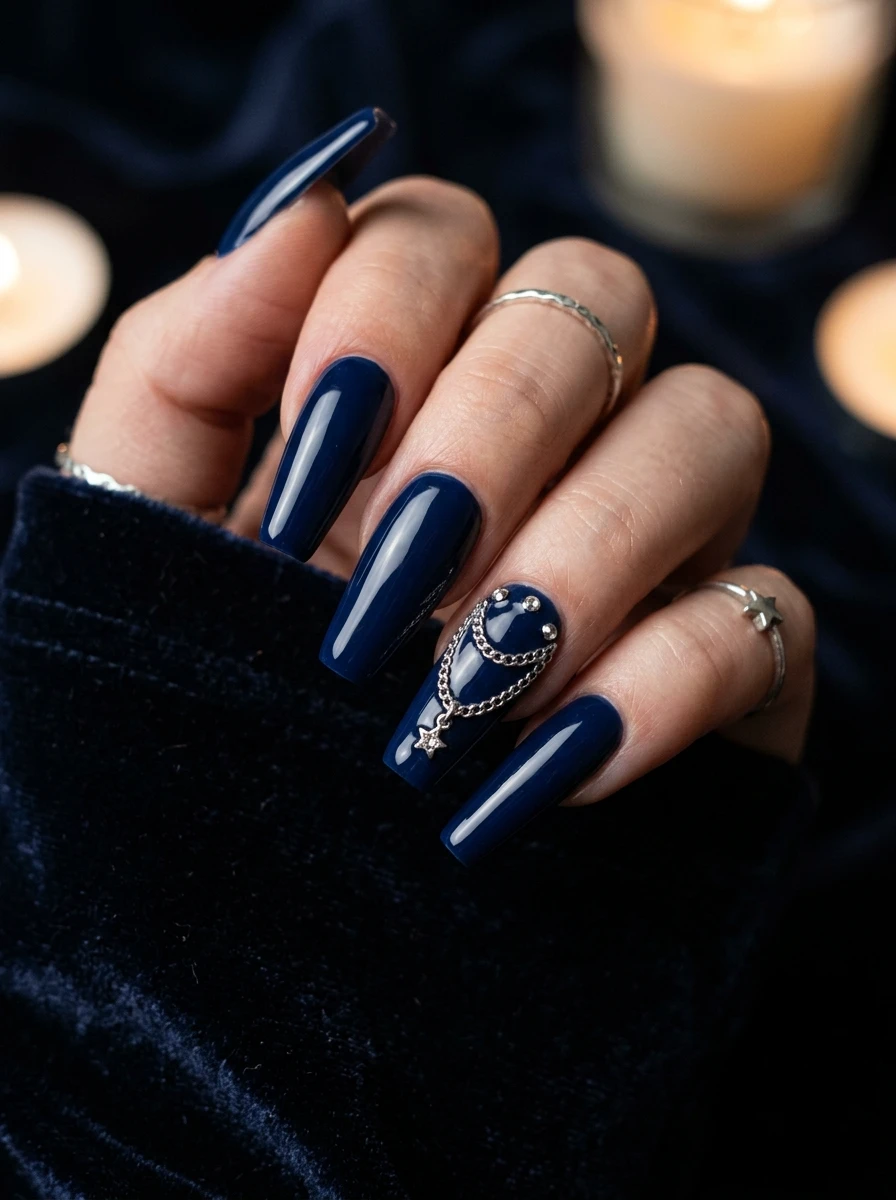 Nails in navy with a silver chain charm accent