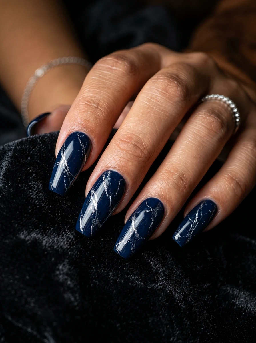 Nails in navy with fine silver vein detail