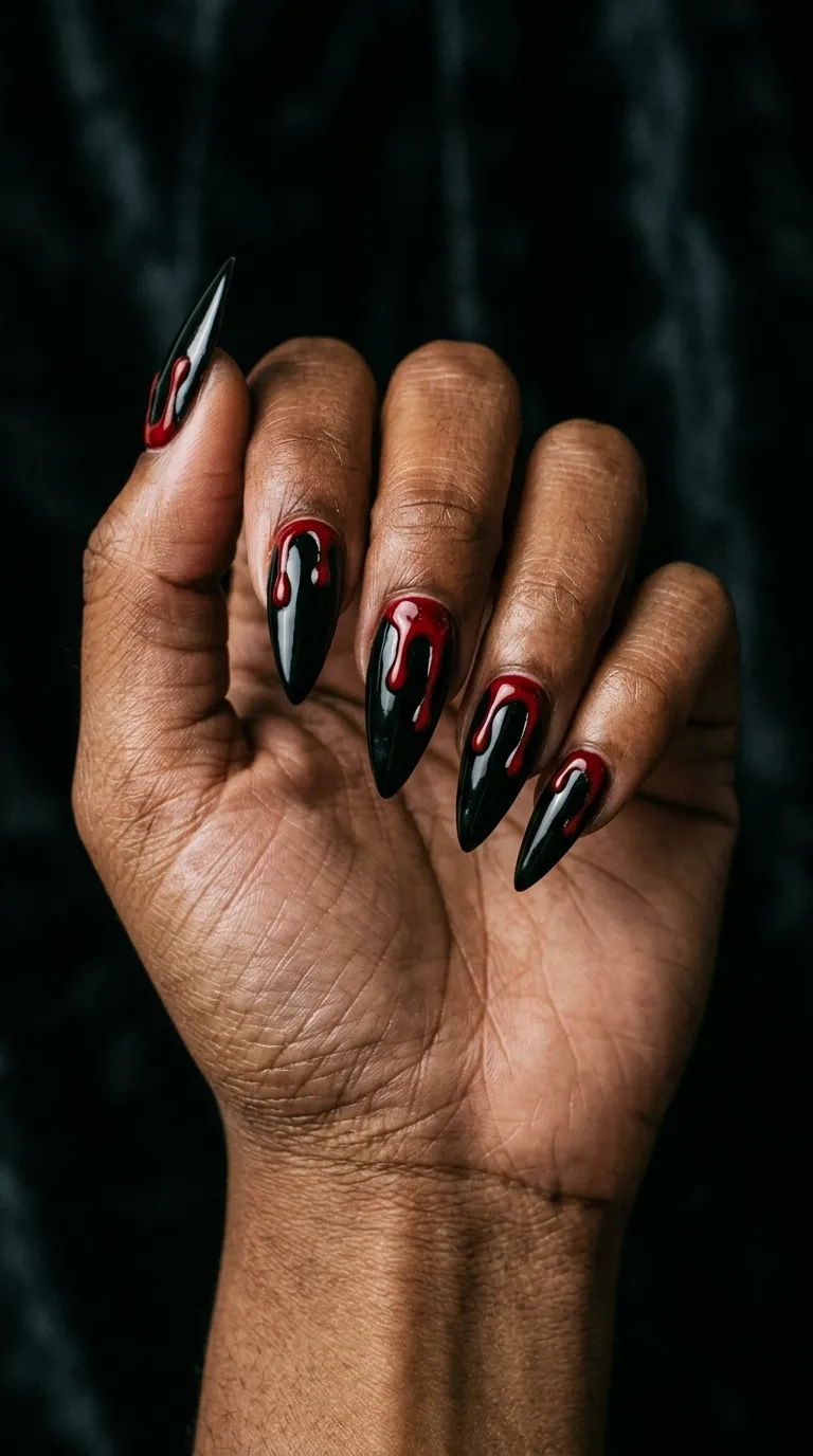 black and red nails with small knife blood-drip accent art