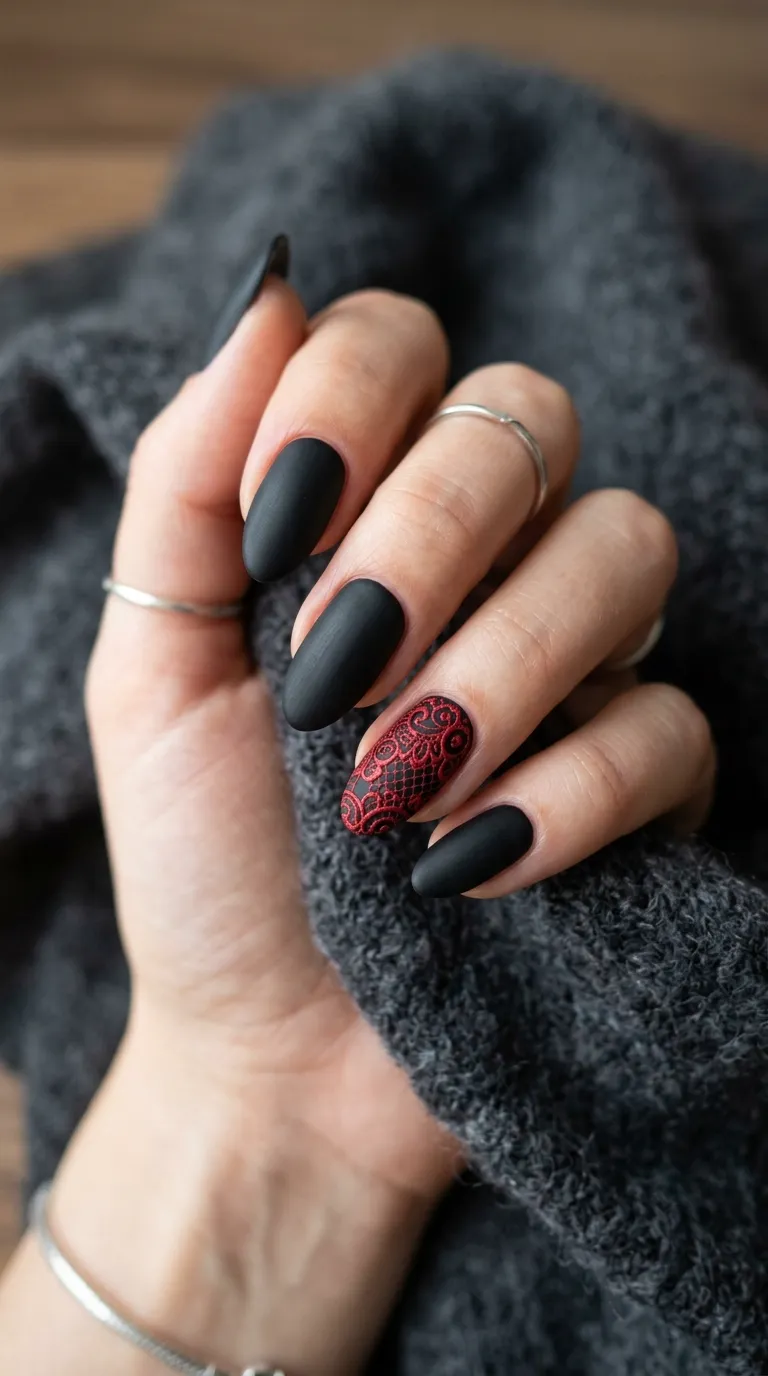 black velvet-matte vampire nails with red lace overlay