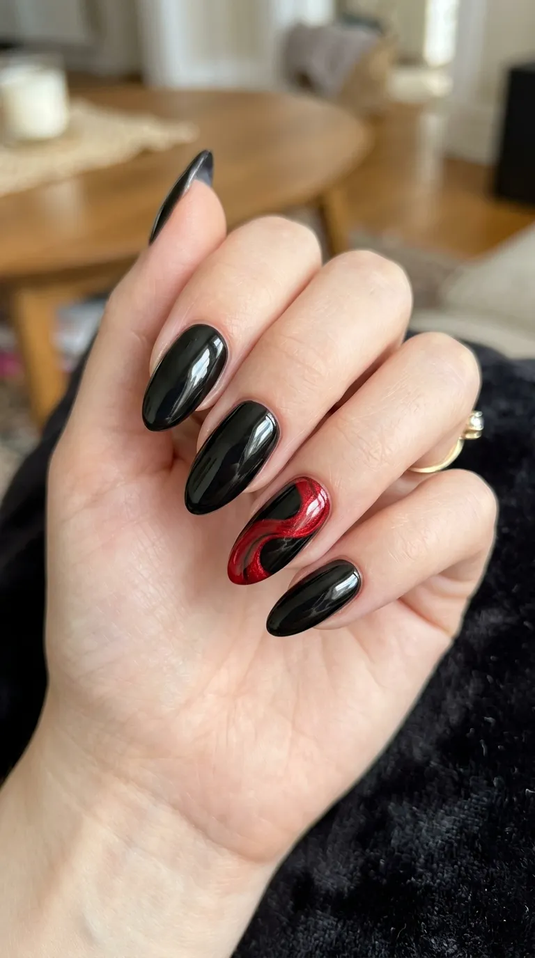 glossy black vampire nails with red cape swirl accent