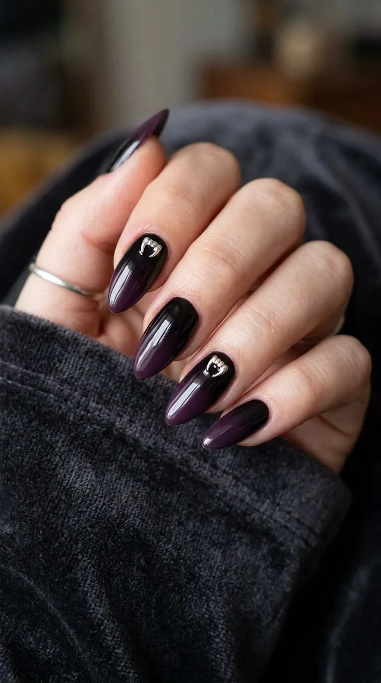 deep purple-black ombre vampire nails with tiny fang charms