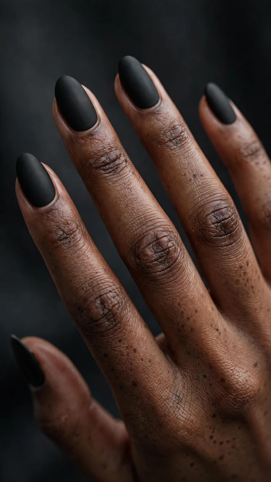 Classic matte black nails on almond-shaped nails