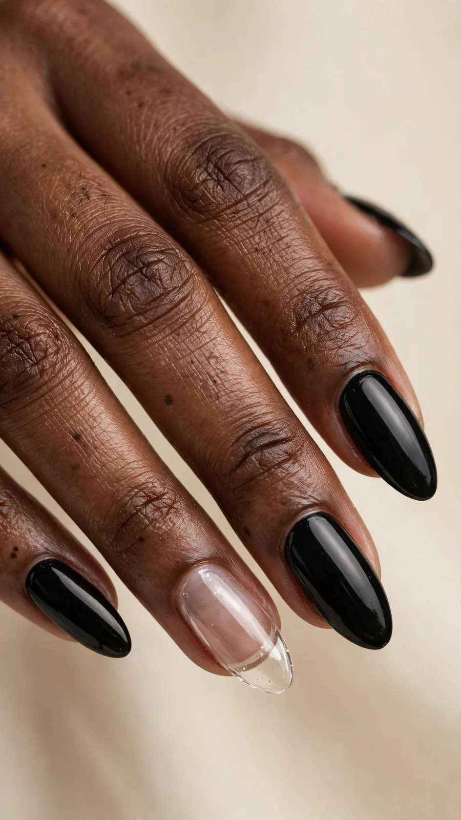 Glossy black nails with clear accent nail