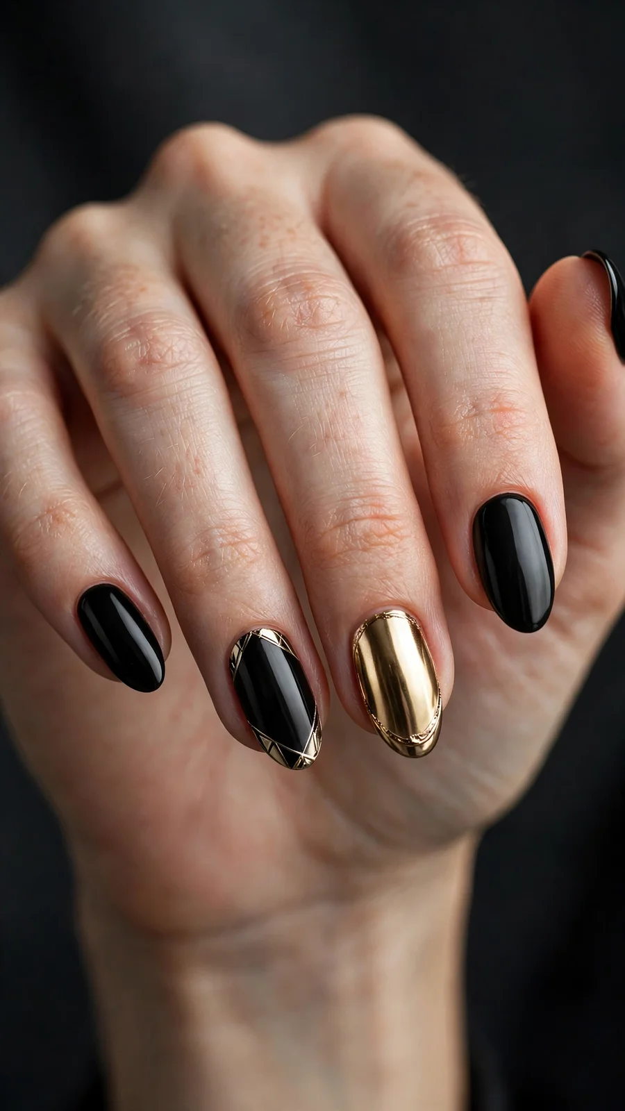Black nails with gold chrome accents