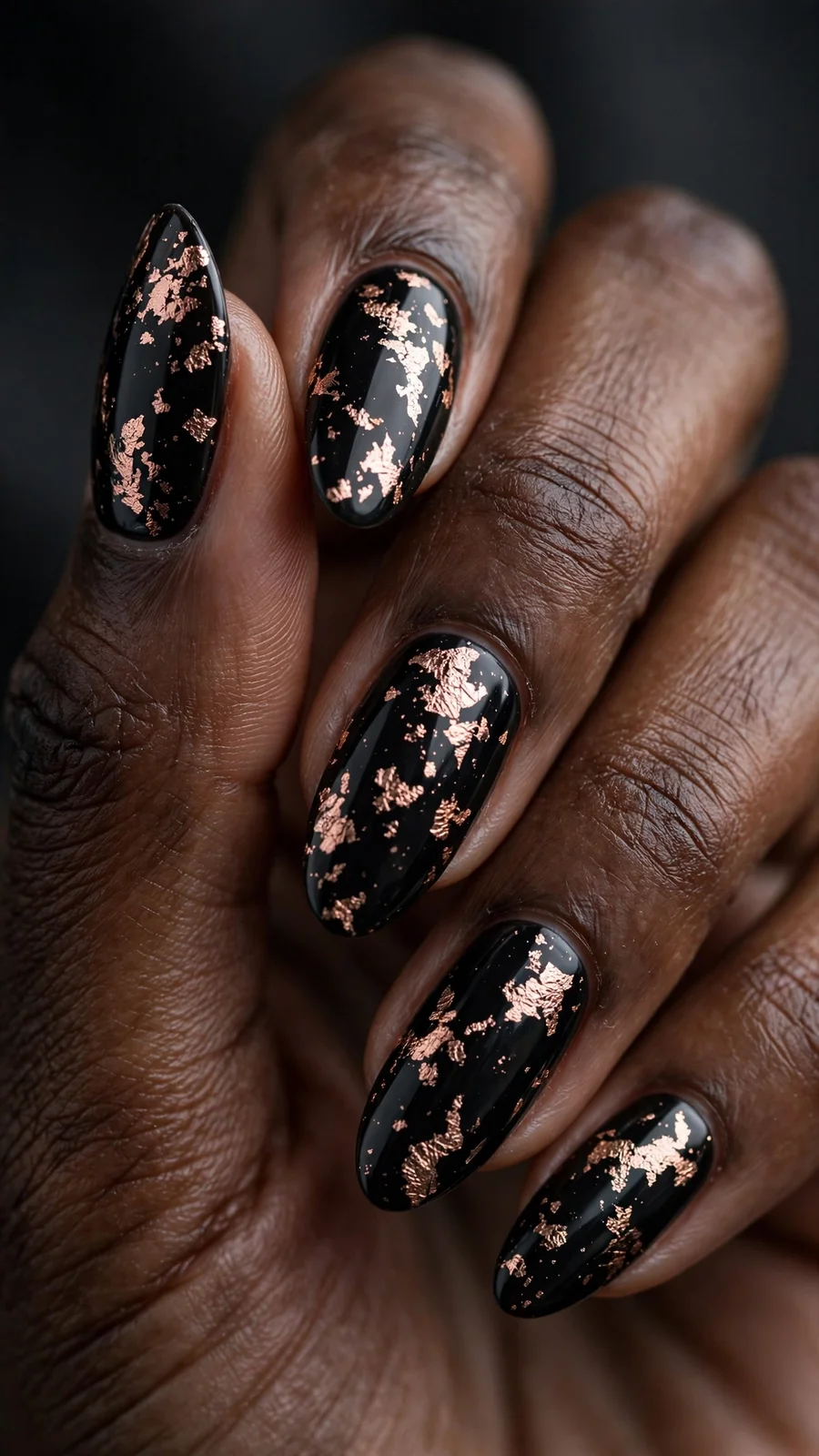 Black nails with rose gold foil flakes
