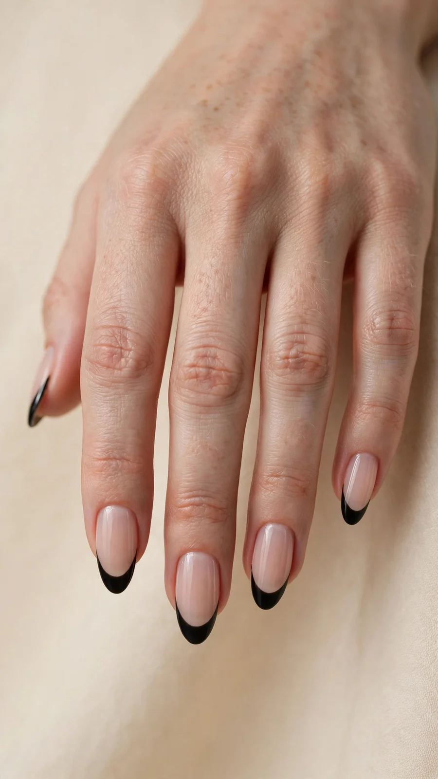 Black French tip nails on nude base