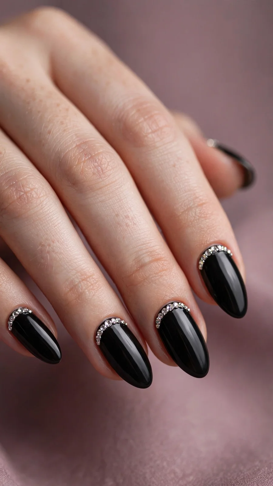 Black nails with rhinestone cuticle detailing