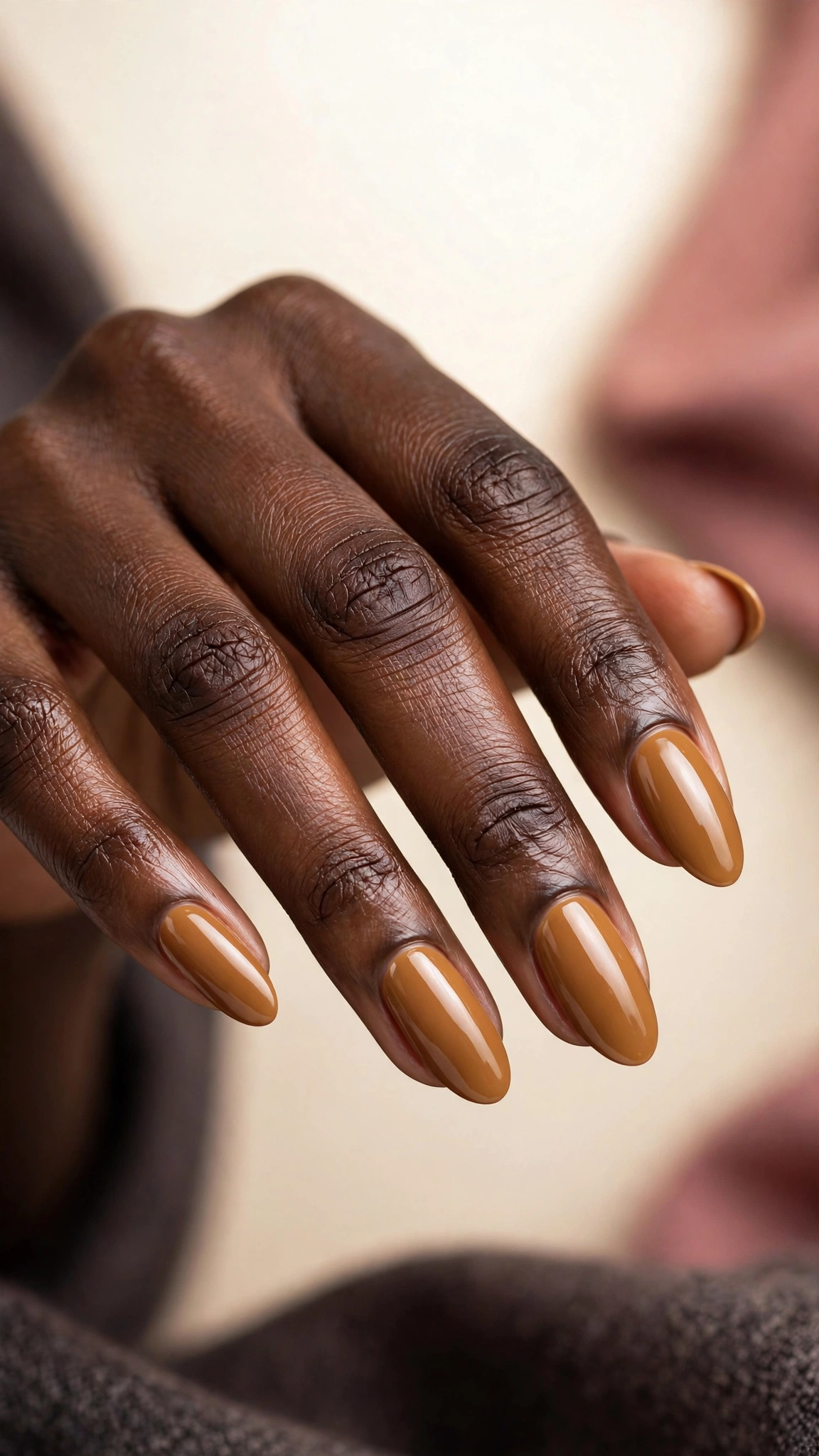 Warm caramel creme nail polish, golden glossy, on dark skin hands