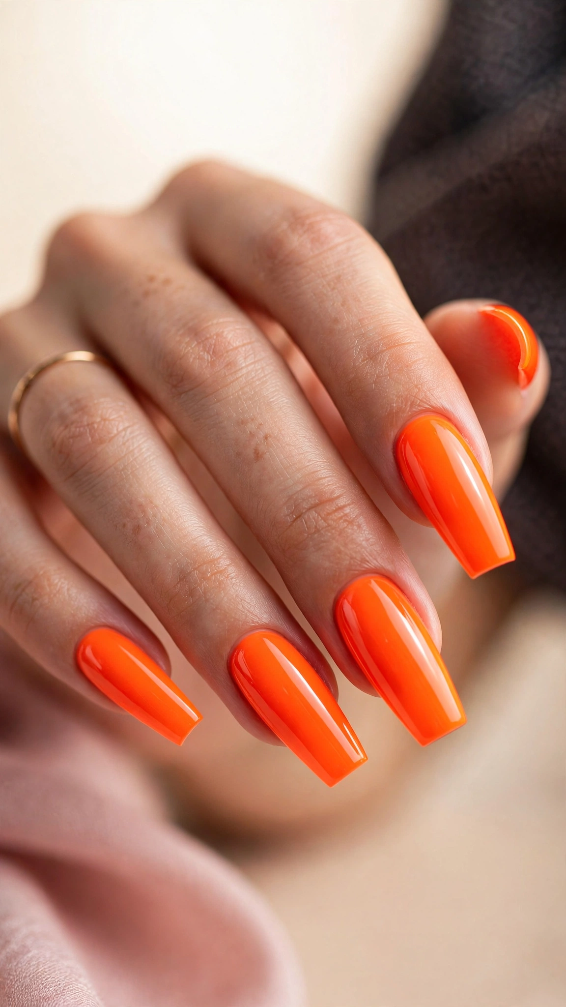 Electric neon orange nails glowing bright on coffin-shaped nails