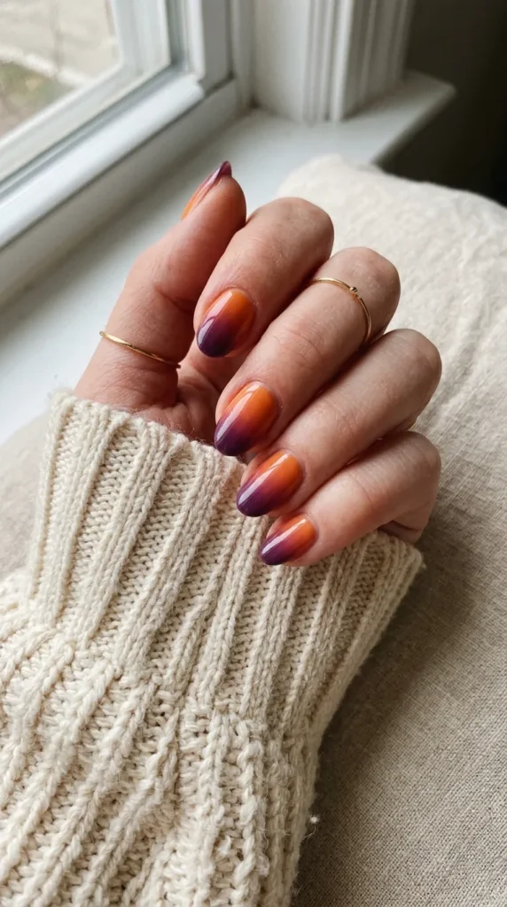 Nails with an orange to plum sunset gradient