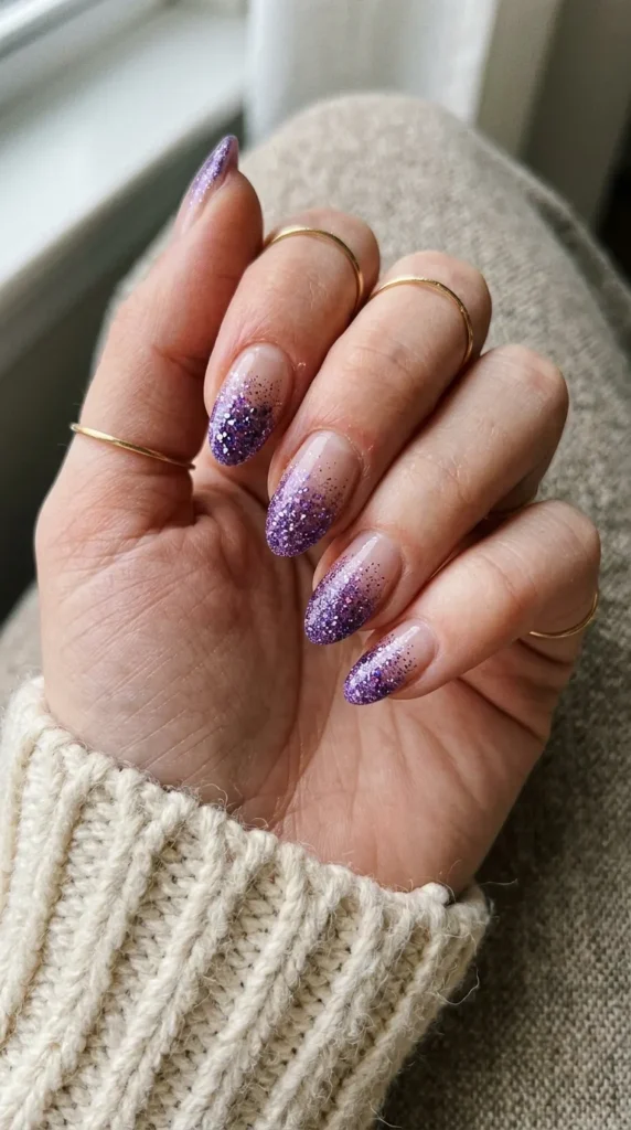 Nails with amethyst purple glitter fading from the tips