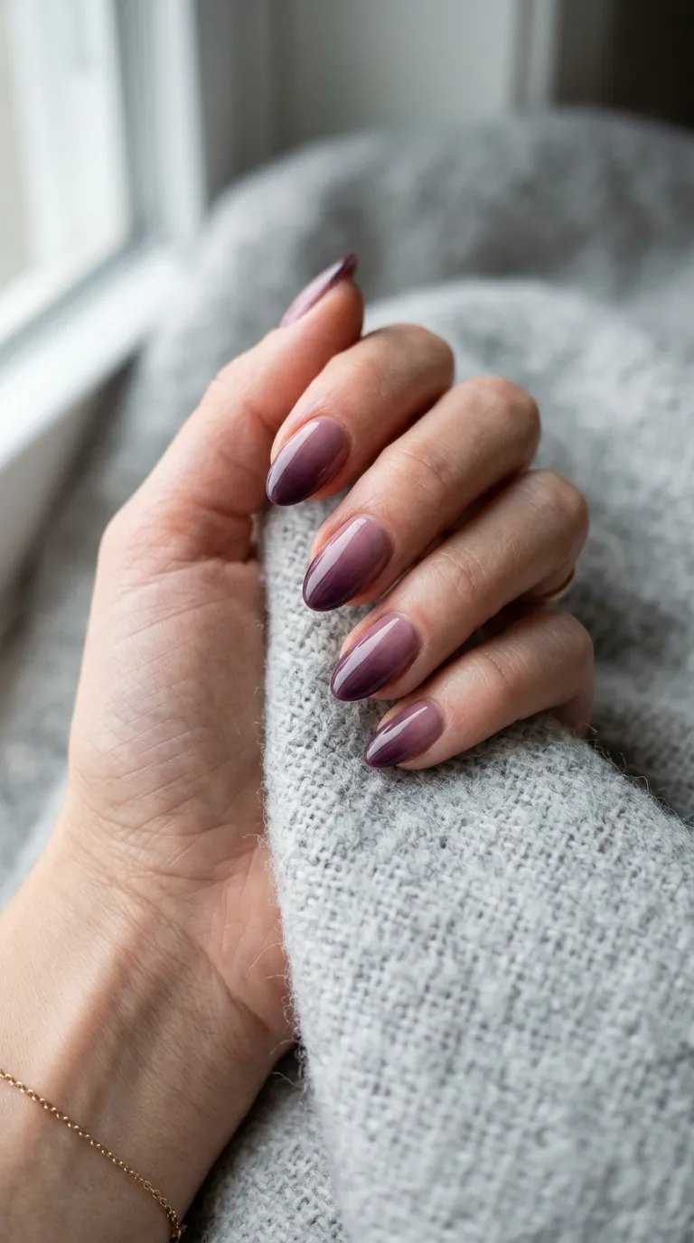 Translucent jelly plum almond nails on a soft grey wool blanket