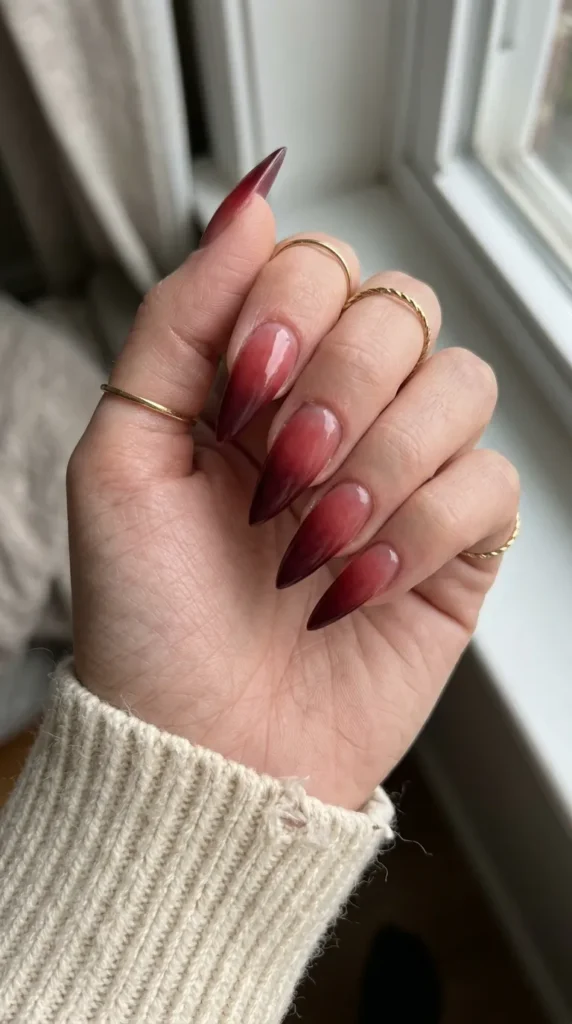 Stiletto nails with a red to burgundy ombre fade
