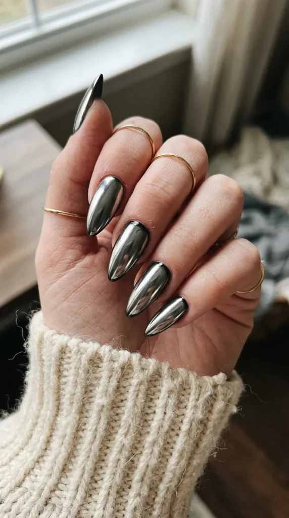 Silver chrome stiletto nails with a mirror finish on black base