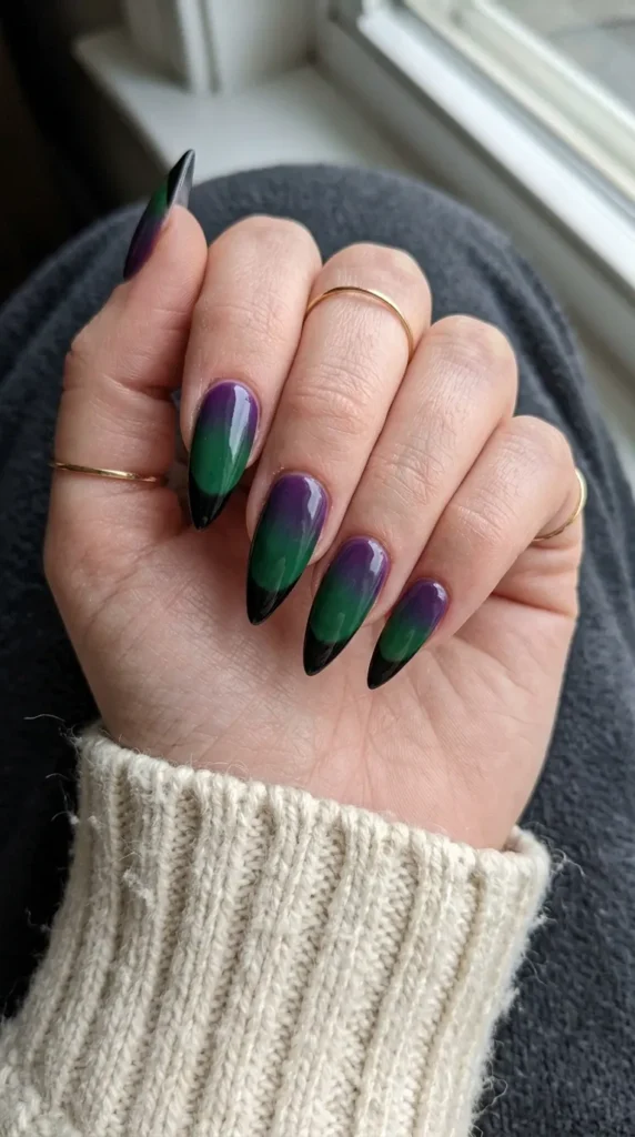 Stiletto nails with a purple to green witch gradient and black tips