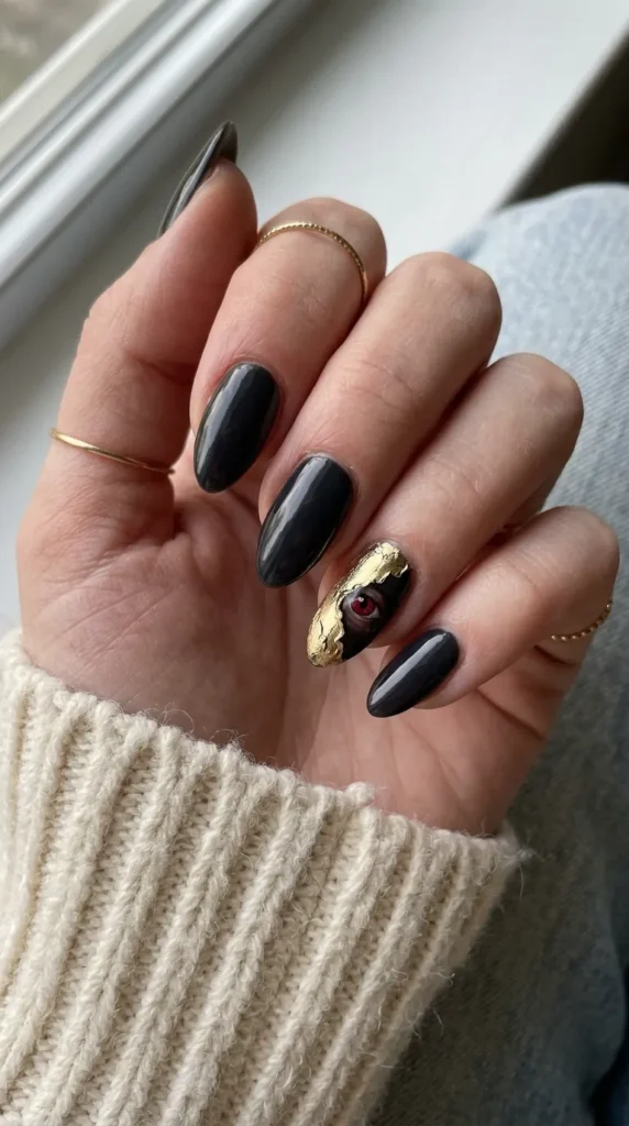 Nails with a torn foil edge revealing a small red eye underneath