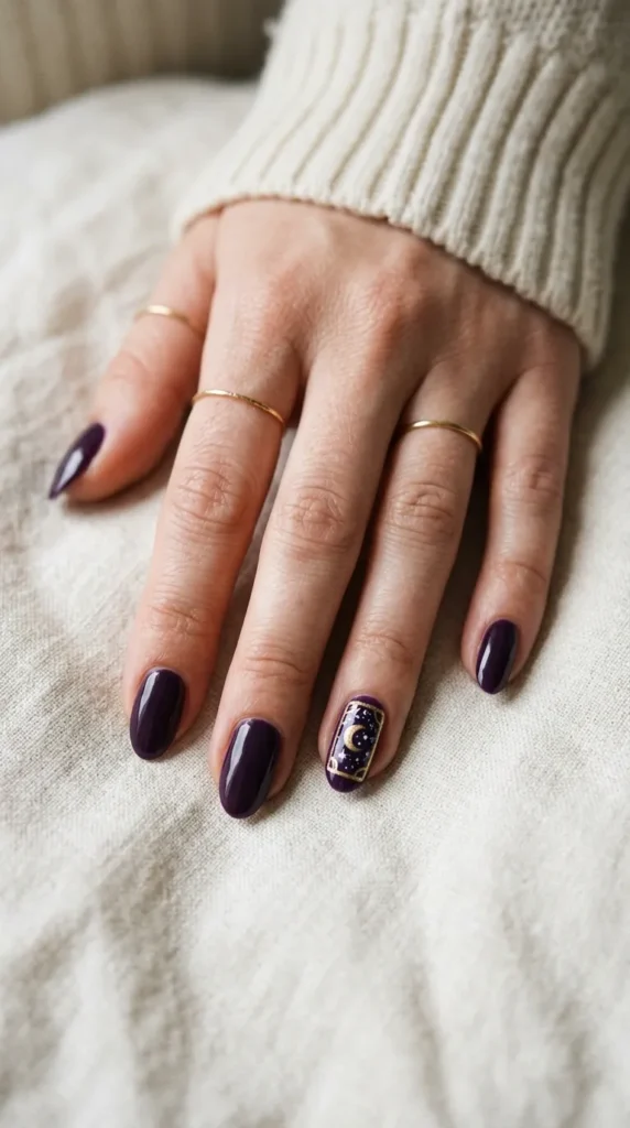 Dark purple nail with a gold-bordered mini tarot card moon design