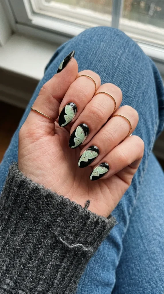 Black nail with a pale green luna moth wing painting