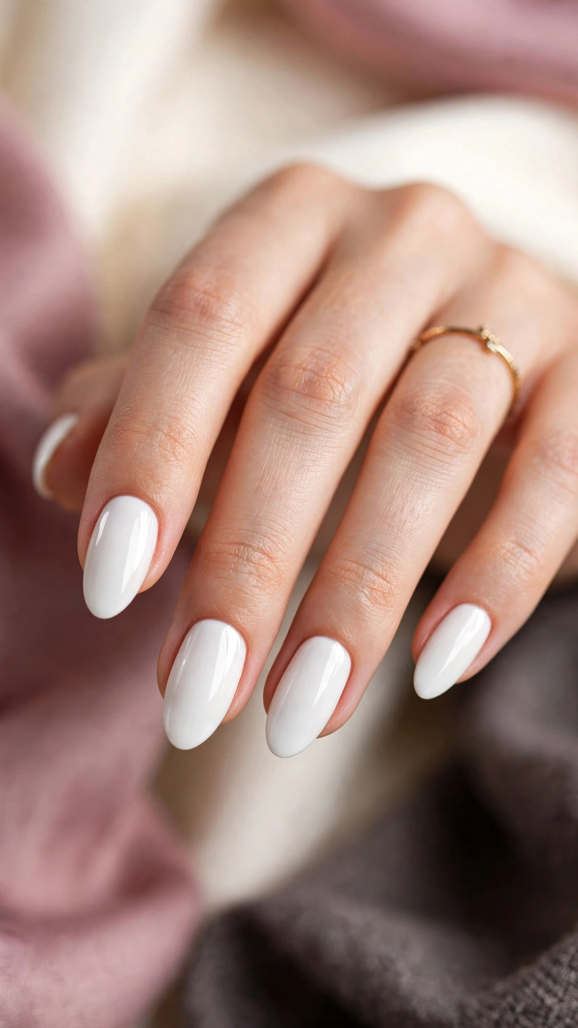 Classic bright white glossy manicure on almond nails